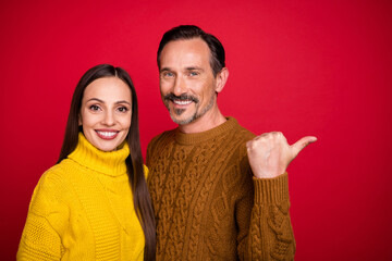 Portrait of two persons positive cheerful indicate thumb empty space offer isolated on red color background