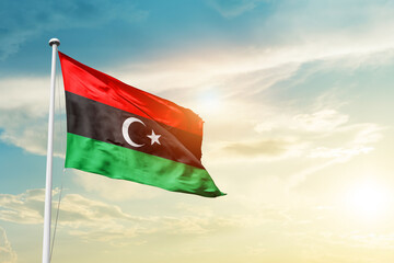 Libya national flag cloth fabric waving on the sky - Image - obrazy, fototapety, plakaty