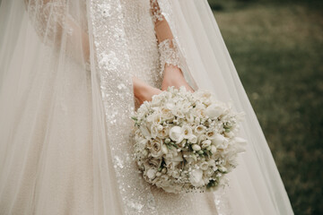  Wedding bouquet in bride hands. Wedding ceremony. Bouquet with white roses.  