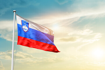 Slovenia national flag cloth fabric waving on the sky - Image