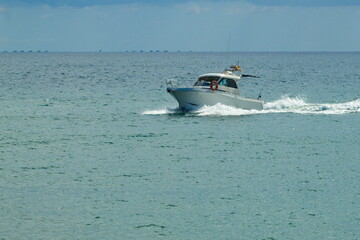 Fototapeta premium Nice seascape with boats going through the surf in vacation time