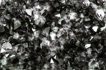 Tourmaline black crystals. Gems. Mineral crystals in the natural environment. Texture of precious and semiprecious stones. Seamless background with copy space colored shiny surface of precious stones.