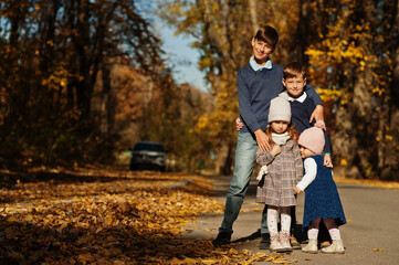 Fototapeta premium Four kids posing at autumn fall park.