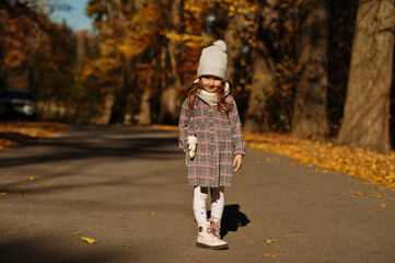 Fototapeta premium Young cute baby girl in hat pose at autumn background.