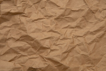 Obraz premium Textured background. Brown rough crumpled kraft paper. Recycled, reuse