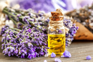 lavender's spa products with dried lavender flowers on a wooden table. Flat lay bath salt and massage oil on wooden background. Skin care, beauty treatment concept. Lavendula oleum