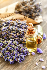 lavender's spa products with dried lavender flowers on a wooden table. Flat lay bath salt and massage oil on wooden background. Skin care, beauty treatment concept. Lavendula oleum