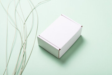 White cardboard box decorated with grass leaf