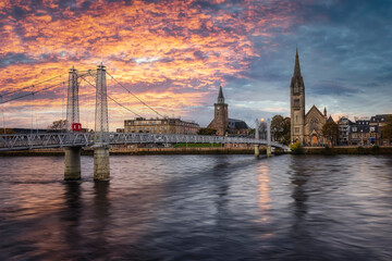 The cityscape of Inverness with Greig Street Bridge and River Ness during a colorful sunset, Scotland