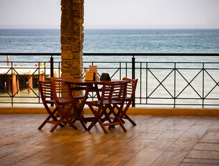 Summer cafe on the terrace overlooking the sea. Pier, shore, surf, Photography.