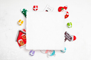 Blank Christmas square greeting card surrounded by Christmas decorations