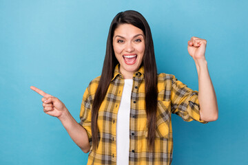 Photo of mature woman happy smile indicate finger empty space advertise select rejoice victory...