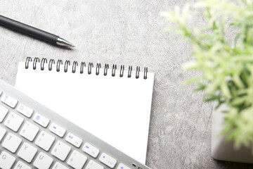 White desk office with laptop, smartphone and other work supplies with cup of coffee. Top view with copy space for input the text. Designer workspace on desk table essential elements on flat lay