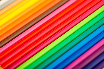 School stationery items. Creation Multicolored pencils on a blank white sheet. On a white background. Children's drawing, artist.