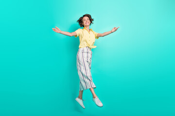 Full size profile side photo of young girl happy positive smile jump go open arms welcome isolated over teal color background