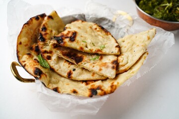 Fresh Tandoori Roti or Butter Naan isolated on white, selective focus