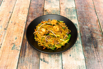 A chive, a piece of zucchini, some peas, a piece of tofu, a few cubes of bacon or cooked ham, a steak, some leftover roast or pull pork, some prawns, an egg, some bean sprouts, a carrot, some prawns