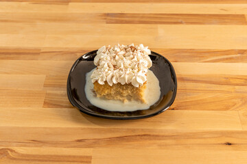 Latin American tres leches cake consisting of a sponge cake bathed in three types of milk: evaporated milk, heavy cream and condensed milk and cream on top