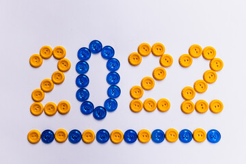 New Year's concept. Photo of the coming New Year made with yellow and blue buttons.