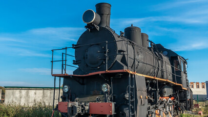 Retro Soviet steam locomotive. Veteran railways. Vintage black steam locomotive train rush railway.
