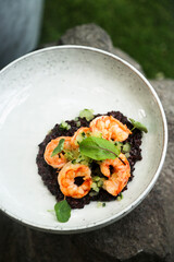 Black risotto with roasted shrimps