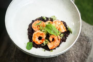 Black risotto with roasted shrimps