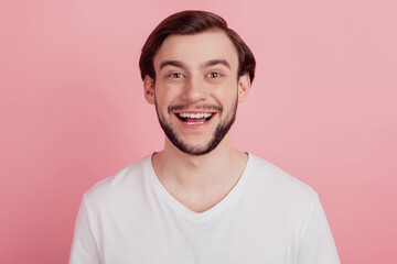 Portrait of funny funky dreamy positive guy look camera on pink background