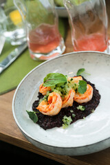 Black risotto with roasted shrimps