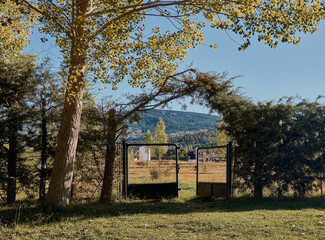 Open the farm gate. Countryside gate road