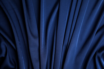 Crumpled dark blue silk fabric as background, top view