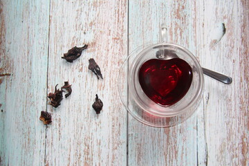 Red Hibiscus tea in glass mug.