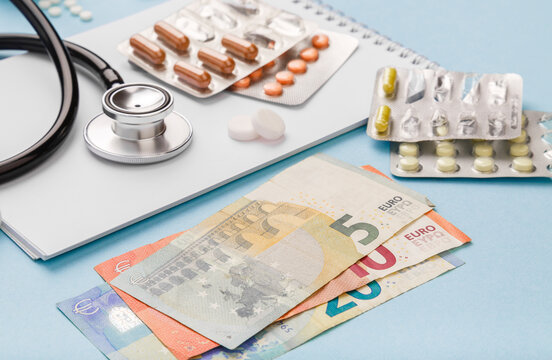 Cost of health care with EURO bank notes, stethoscope and medicaments. Price of medicine. Medical expenses. EURO small bills cash money. Cost of medicinal products and treatment concept