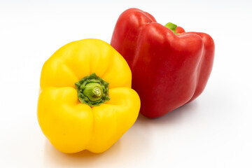 Yellow and red bell peppers on white background with shadow. close up