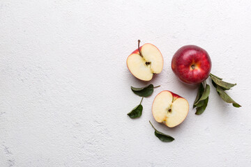 Fresh red apples with green leaves on wooden table. On wooden background. Top view free space for text