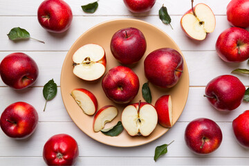 juicy red apples in a bowl or plate on the table top view. Copy space