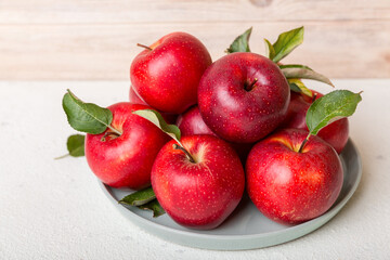 juicy red apples in a bowl or plate on the table top view. Copy space