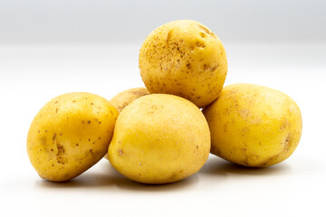 Fresh potatoes on white background with shadow. Close up