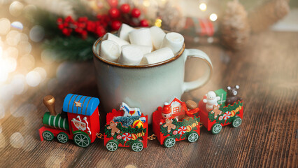 Obraz na płótnie Canvas santa claus christmas locomotive on white wooden background with bokeh ,christmas concept
