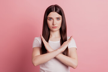 Portrait of serious strict girl cross hands stop no sign reject refuse enough isolated over pastel color background