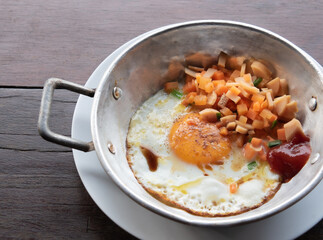 Kai ka tha or Fried Egg in Soy Sauce with Sausage and Carrots in pan. Simple Thai breakfast.