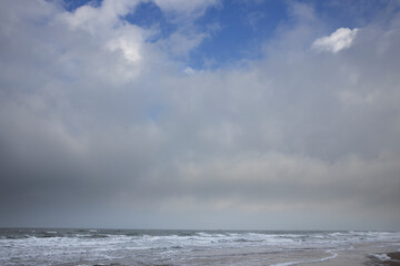 Clouds. Blue sky. Waves sea. Julianadorp coast Netherlands. Northsea.