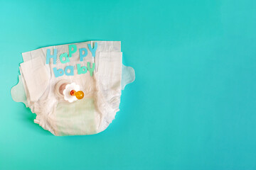 Baby diapers, pacifier and the inscription 