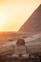sunset behind the sphinx and pyramid in Egypt