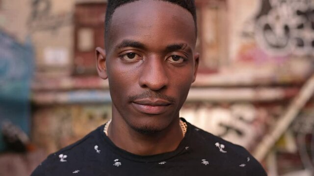 Portrait of a young black guy who smiles and looks directly at the camera. close up