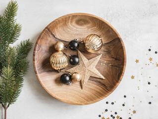 Christmas or New Year background - wooden plate with various Christmas balls and gold star on white...