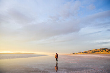 traveler walking on the salt flats at sunset in turkey