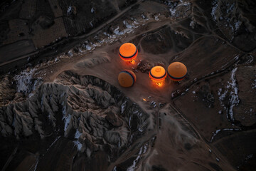 hot air balloons glowing on the valley floor of Cappadocia turkey