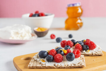 Healthy breakfast. Sandwich for kids. Slimming. Healthy lifestyle. Raspberries, blueberries, passion fruit, and cottage cheese. Sandwiches with cottage cheese. Whole wheat bread.