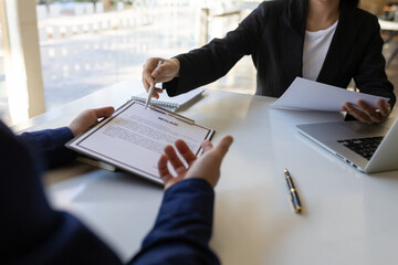Man explaining resume and answering questions while interviewing new employees.