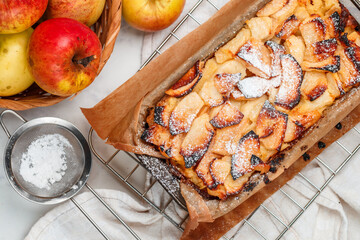 Freshly baked homemade apple pie close-up on a marble background. The concept of autumn baking. Selective focus, top view